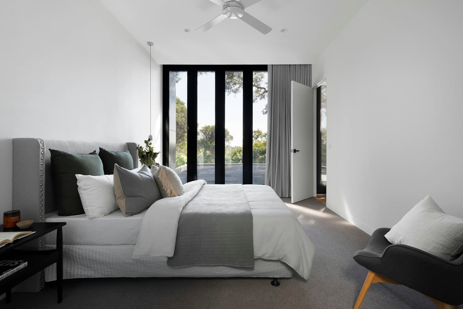 Bright master bedroom with garden-facing windows