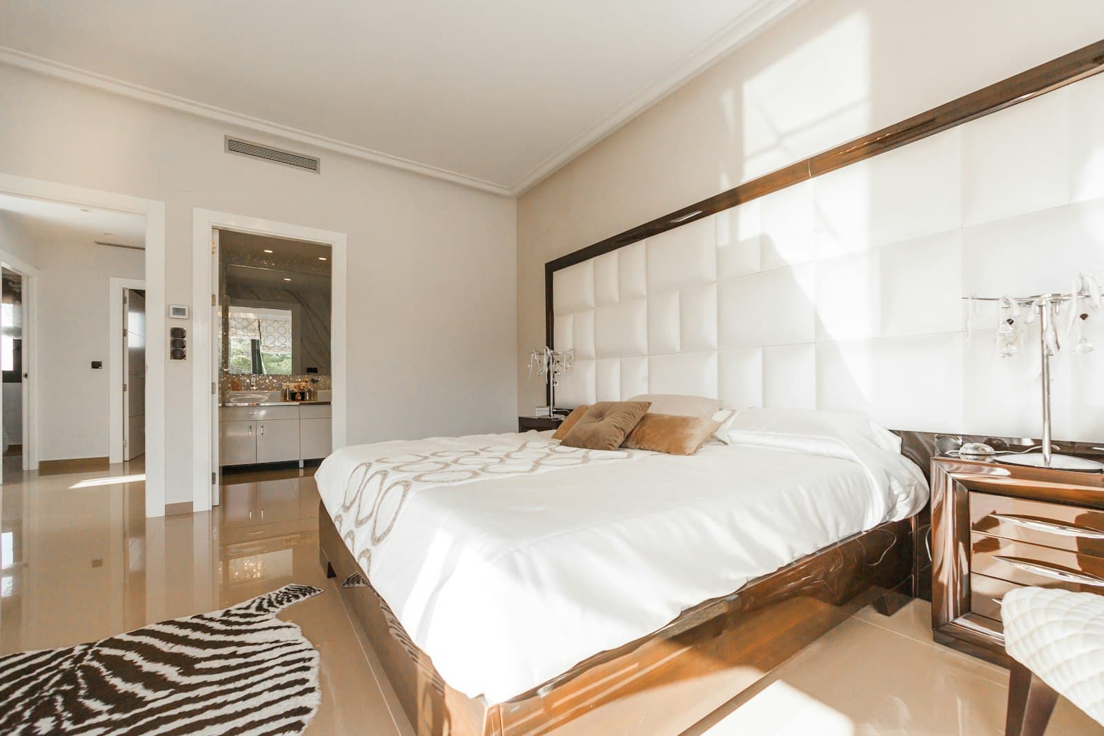 Master bedroom with padded headboard wall