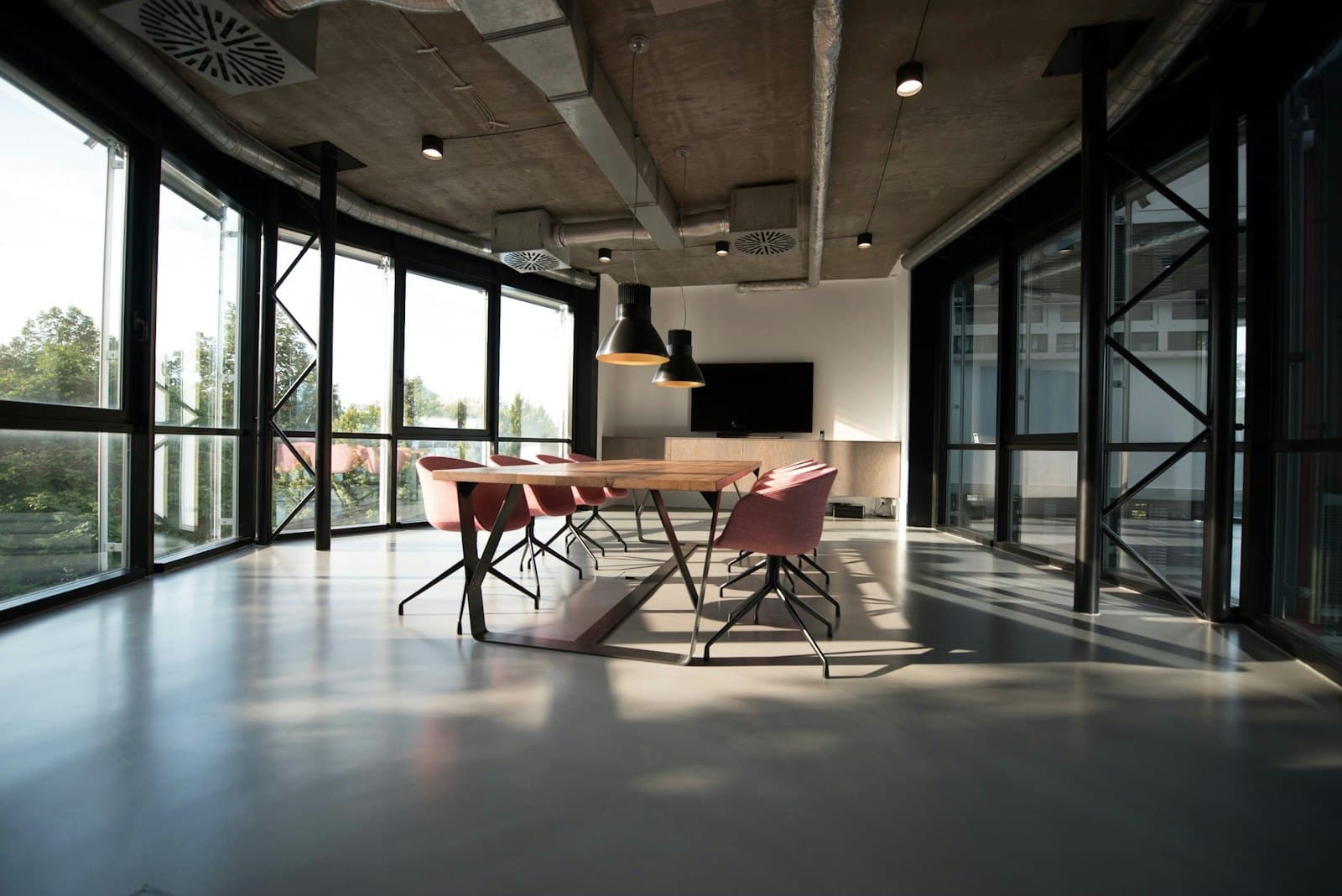 Open-plan office floor with meeting table and city views